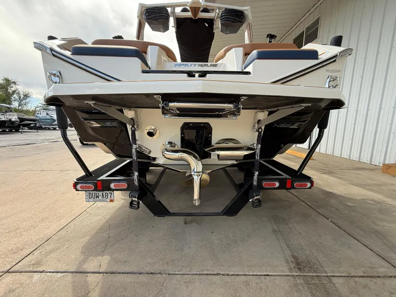 Slide: The Image of 2024 Nautique G21 boat rear view, showcasing sleek design and advanced features. - 6