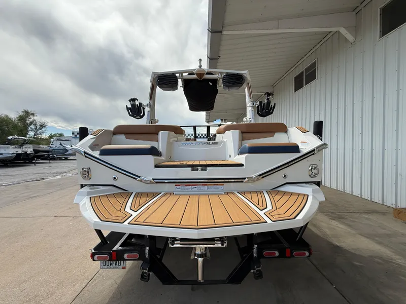 Slide: The Image of 2024 Nautique G21 boat with teak deck, docked at marina. - 7