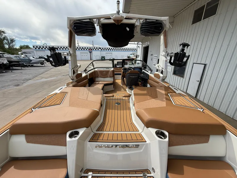 Slide: The Image of 2024 Nautique G21 boat interior with tan seating and sleek design. - 8
