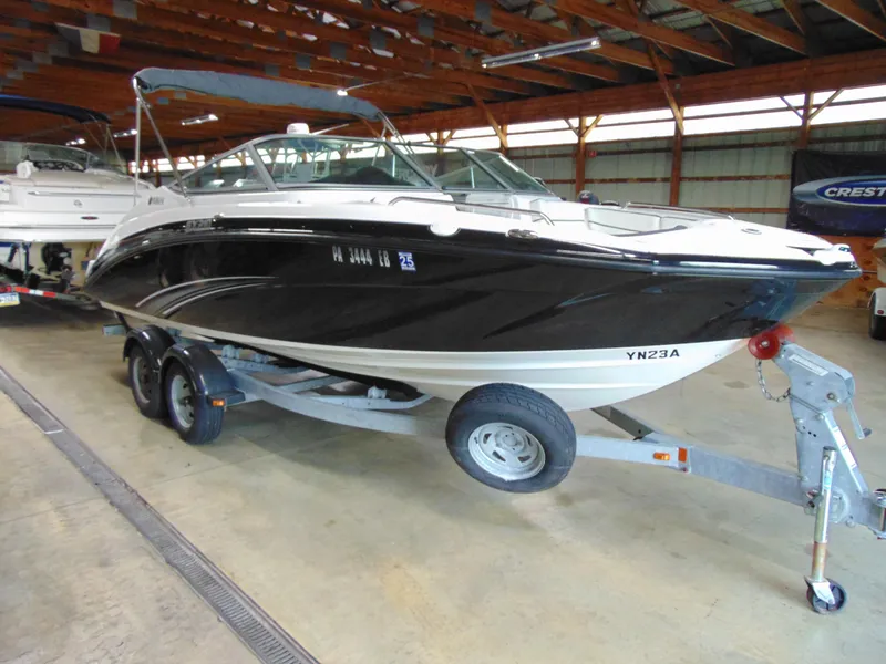 Slide: The Image of 2014 Yamaha Boats SX210 on trailer in indoor storage facility. - 1