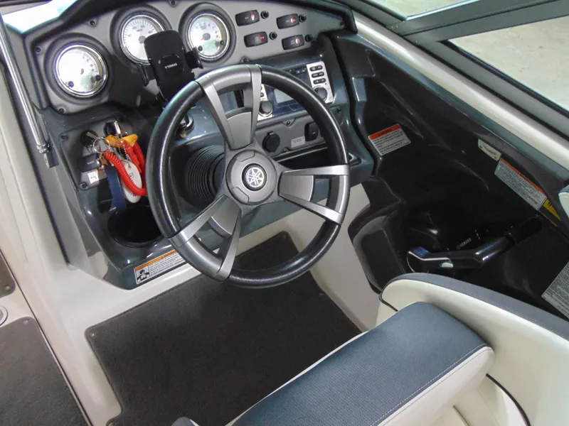 Slide: The Image of 2014 Yamaha SX210 boat dashboard with steering wheel and instrument panel. - 13