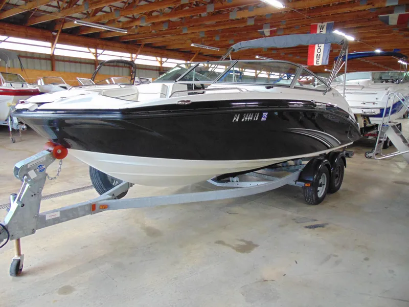 Slide: The Image of 2014 Yamaha Boats SX210 on trailer in indoor storage facility. - 2