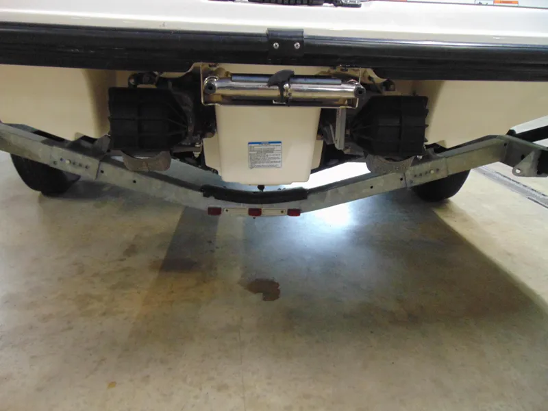 Slide: The Image of Rear view of a 2014 Yamaha SX210 boat on a trailer indoors. - 6