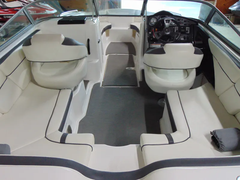 Slide: The Image of 2014 Yamaha Boats SX210 interior with spacious seating and modern dashboard. - 7