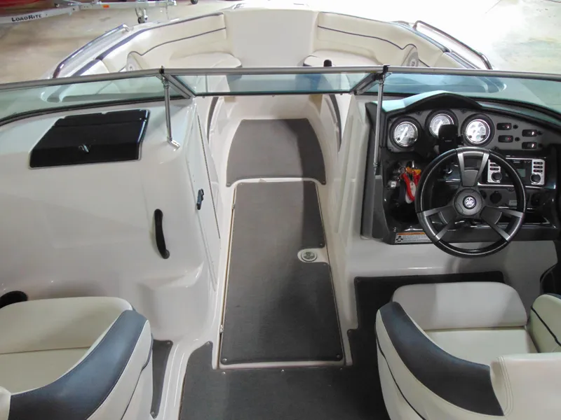 Slide: The Image of 2014 Yamaha Boats SX210 interior with steering wheel and seating area. - 8