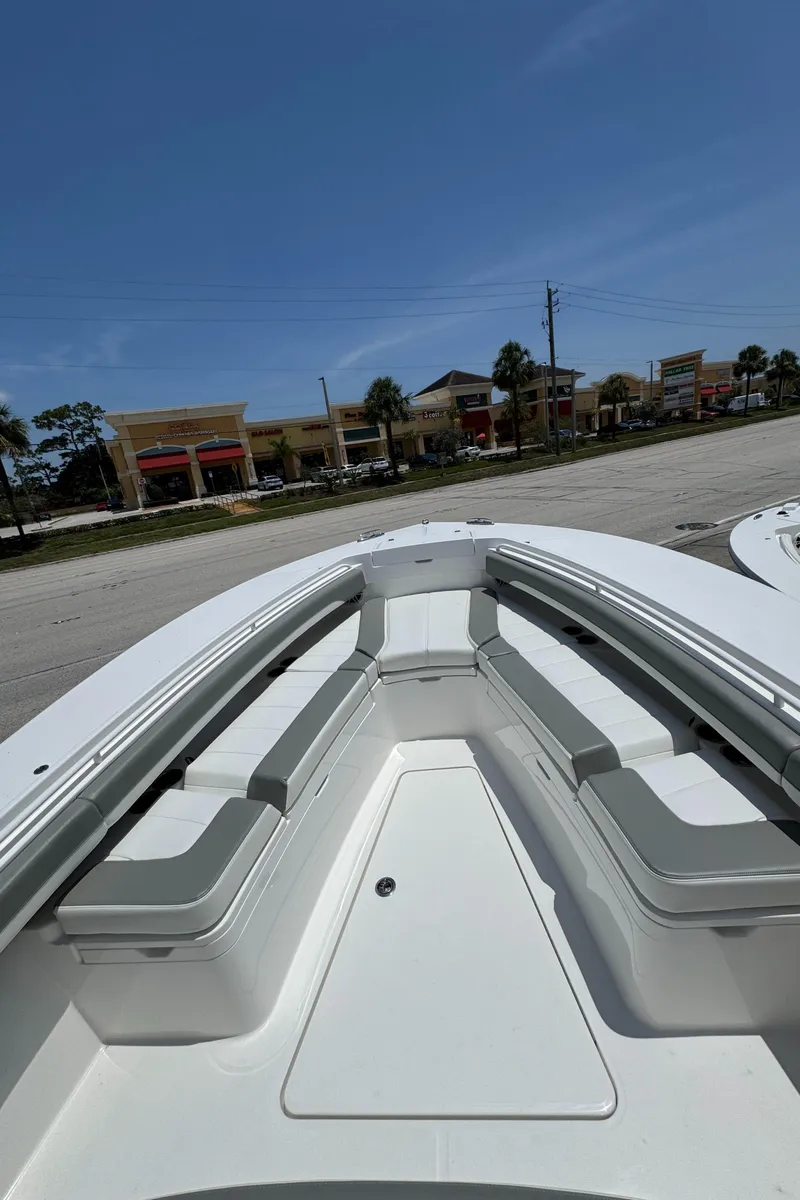 Slide: The Image of 2025 Regulator 28 boat with spacious seating, parked outdoors under a clear blue sky. - 10