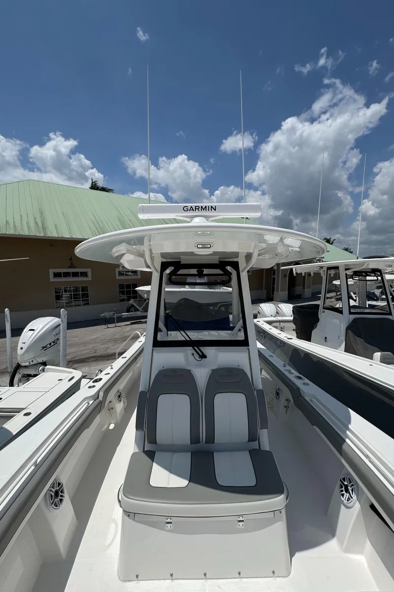 Slide: The Image of 2025 Regulator 28 boat with Garmin equipment, docked under a clear blue sky. - 11