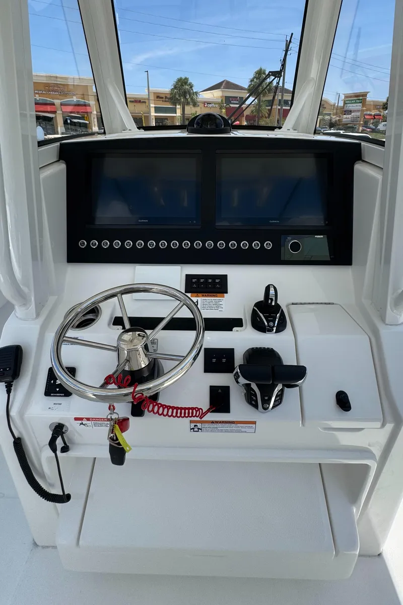 Slide: The Image of Helm of 2025 Regulator 28 boat with dual screens and steering wheel. - 6