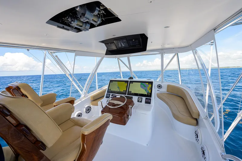 Slide: The Image of Helm of 2022 F&S 58 Custom Carolina yacht with navigation screens and ocean view. - 10