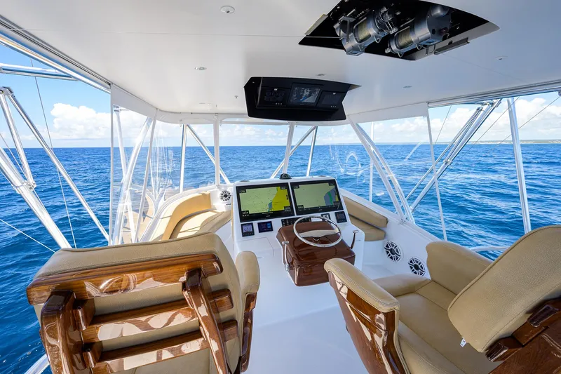 Slide: The Image of 2022 F&S 58 Custom Carolina yacht helm with ocean view, featuring modern navigation equipment. - 11