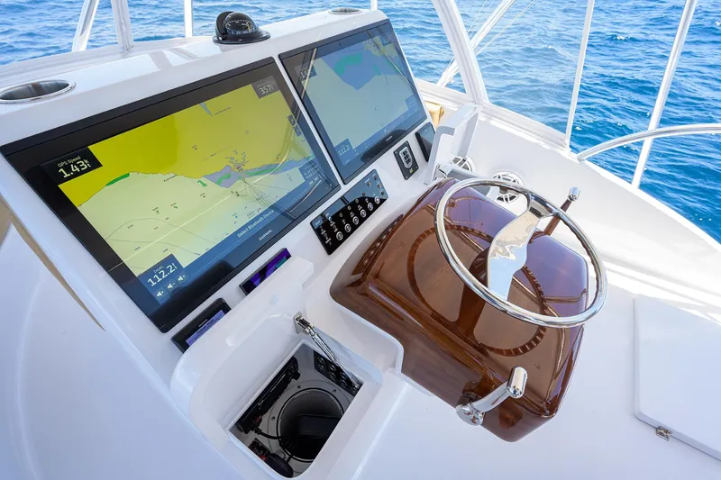 Slide: The Image of Helm of 2022 F&S 58 Custom Carolina yacht with dual navigation screens. - 12
