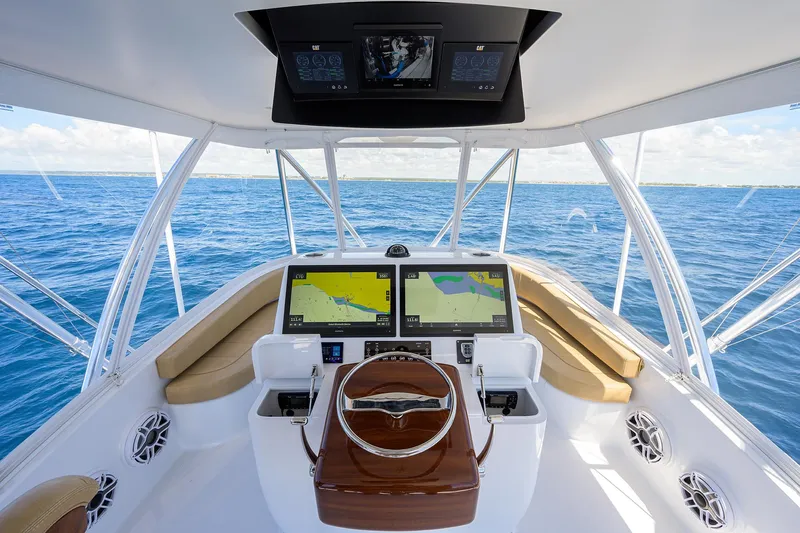 Slide: The Image of Cockpit of 2022 F&S 58 Custom Carolina yacht with dual navigation screens and ocean view. - 13