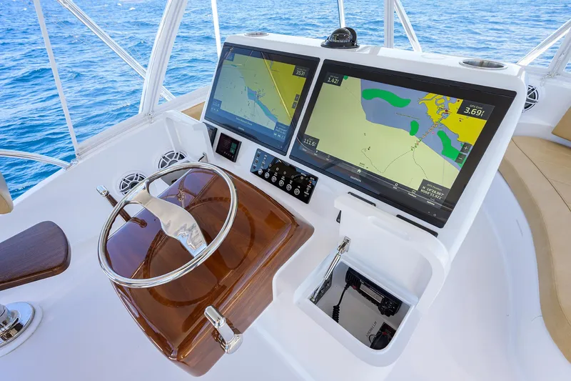 Slide: The Image of Cockpit of 2022 F&S 58 Custom Carolina yacht with dual navigation screens. - 14