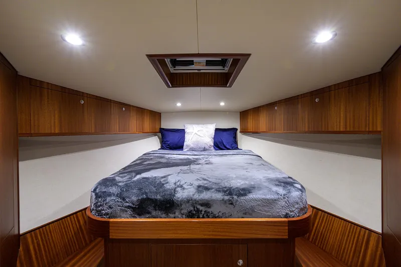 Slide: The Image of Luxurious cabin interior of 2022 F&S 58 Custom Carolina yacht with cozy bed and wooden accents. - 19