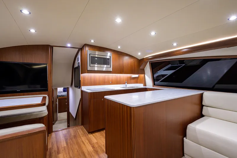 Slide: The Image of Luxurious interior of 2022 F&S 58 Custom Carolina yacht with modern kitchen and seating area. - 21