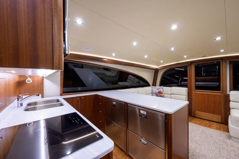 Slide: The Image of Luxurious interior of 2022 F&S 58 Custom Carolina yacht with modern kitchen and seating area. - 24