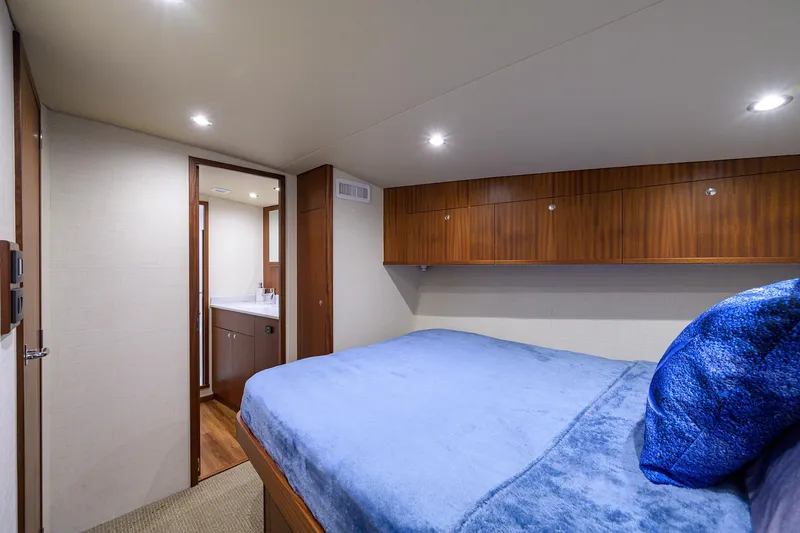 Slide: The Image of Luxurious cabin interior of 2022 F&S 58 Custom Carolina yacht with blue bedding. - 29