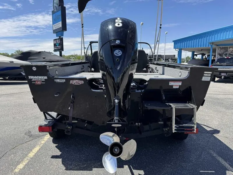 Slide: The Image of 2023 Tracker Targa 18 boat with powerful outboard motor, parked outdoors under clear sky. - 5