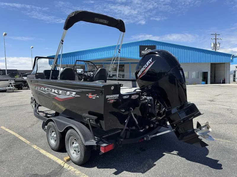 Slide: The Image of 2023 Tracker Targa 18 boat with Mercury engine in parking lot. - 6