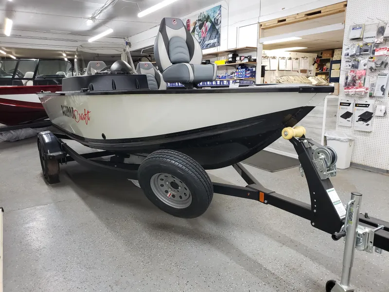 Slide: The Image of 2024 Alumacraft Classic 165cs boat on trailer in showroom. - 2