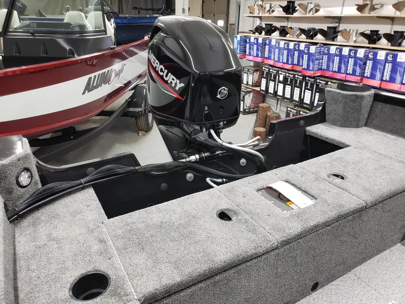 Slide: The Image of 2024 Alumacraft Classic 165cs boat with Mercury outboard motor in showroom. - 6