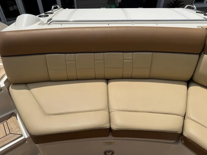 Slide: The Image of Beige leather seating on 2015 Sea Ray 350 SLX boat, featuring cup holders and sleek design. - 10