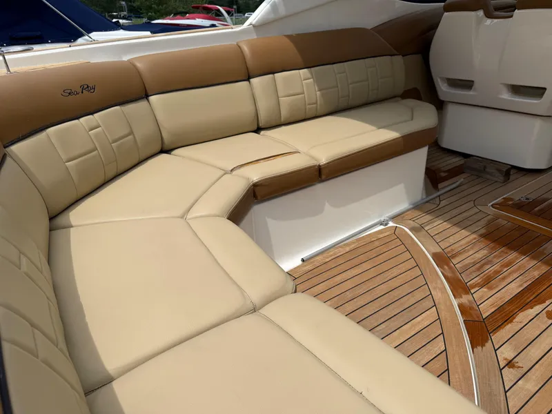 Slide: The Image of Luxurious seating on 2015 Sea Ray 350 SLX boat with tan upholstery and teak flooring. - 12