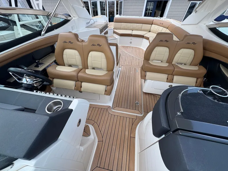 Slide: The Image of 2015 Sea Ray 350 SLX boat interior with luxurious seating and wood flooring. - 14