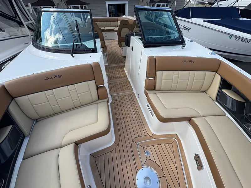 Slide: The Image of 2015 Sea Ray 350 SLX boat interior with tan seating and wood flooring. - 17
