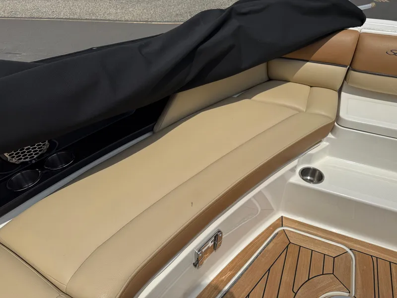 Slide: The Image of 2015 Sea Ray 350 SLX boat interior with tan leather seating and wood flooring. - 19