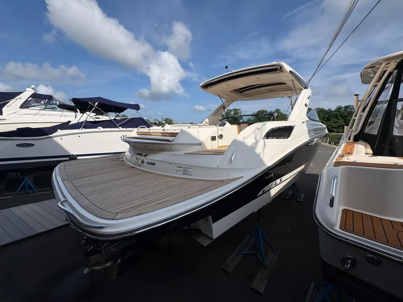 Slide: The Image of 2015 Sea Ray 350 SLX boat on display, featuring spacious deck and sleek design. - 2