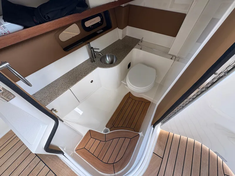 Slide: The Image of Interior of 2015 Sea Ray 350 SLX boat bathroom with sink and toilet. - 21