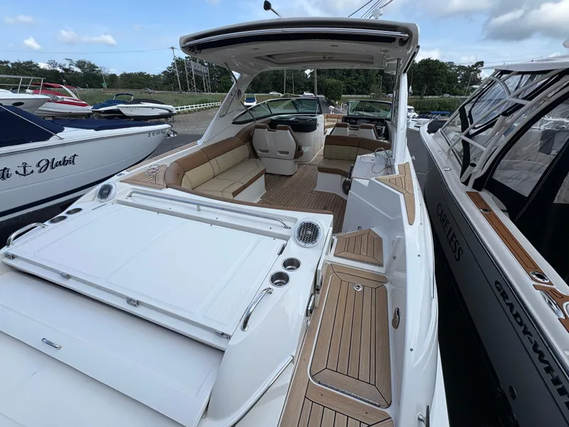 Slide: The Image of 2015 Sea Ray 350 SLX luxury boat with spacious seating and sleek design. - 6