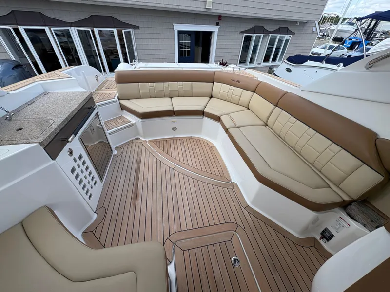Slide: The Image of Luxurious 2015 Sea Ray 350 SLX boat interior with spacious seating and elegant wood flooring. - 8