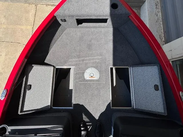 Slide: The Image of 2025 Crestliner 1750 Hawk boat interior with storage compartments, red trim, and carpeted flooring. - 10