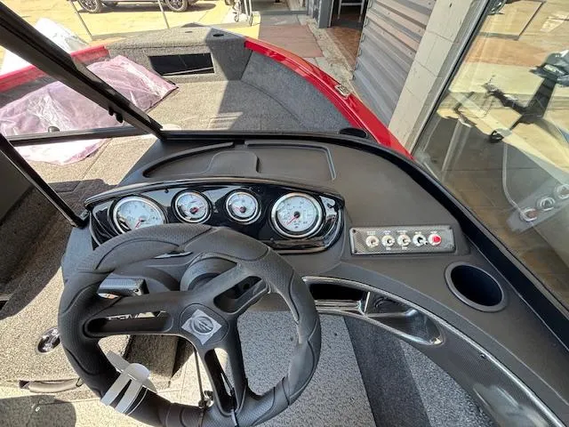 Slide: The Image of 2025 Crestliner 1750 Hawk dashboard with steering wheel and gauges, featuring modern design. - 14