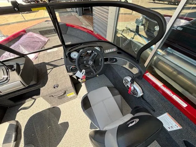 Slide: The Image of 2025 Crestliner 1750 Hawk boat interior with steering wheel and seating. - 15