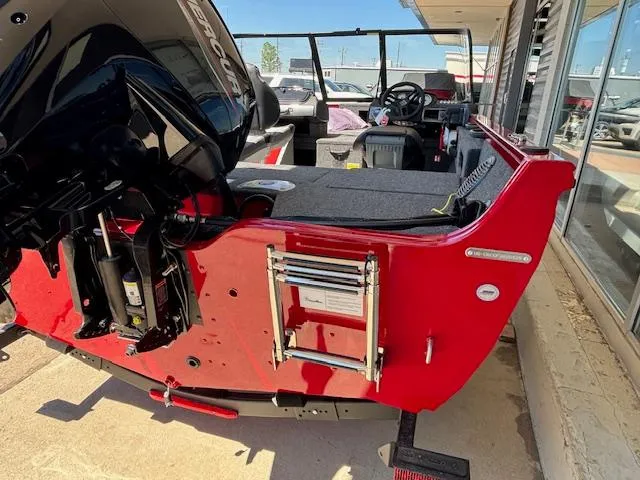 Slide: The Image of 2025 Crestliner 1750 Hawk boat, red exterior, rear view with motor and ladder. - 18