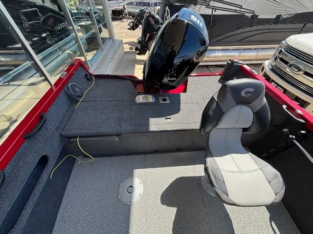 Slide: The Image of 2025 Crestliner 1750 Hawk boat interior with seating and motor, showcasing modern design. - 5