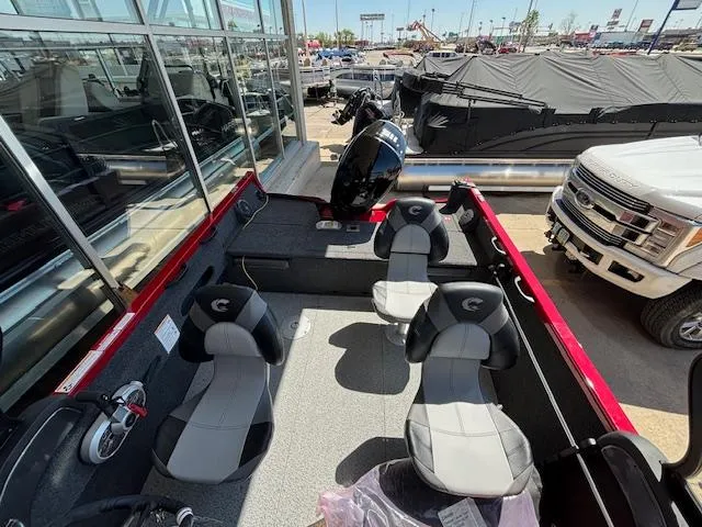 Slide: The Image of 2025 Crestliner 1750 Hawk boat interior with seating and motor, displayed outdoors. - 6