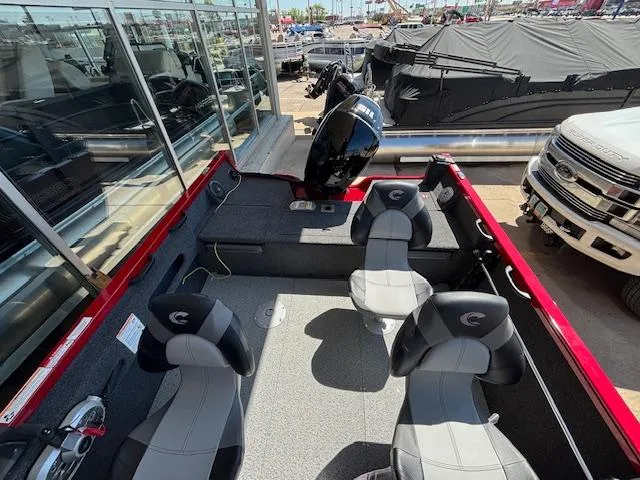 Slide: The Image of 2025 Crestliner 1750 Hawk boat interior with seating and motor, displayed outdoors. - 7