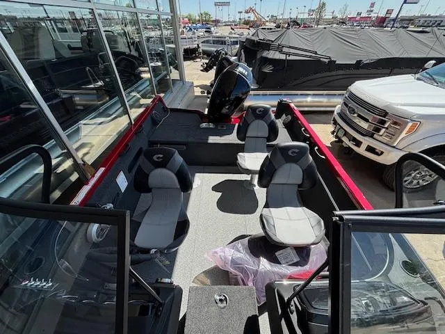 Slide: The Image of 2025 Crestliner 1750 Hawk boat interior with seating and motor, displayed outdoors. - 8