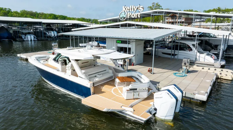 Slide: The Image of 2024 Tiara Yachts 43 LS docked at Kelly's Port marina. - 12