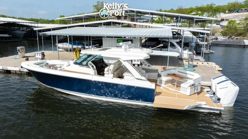 Slide: The Image of 2024 Tiara Yachts 43 LS docked at Kelly's Port marina. - 13