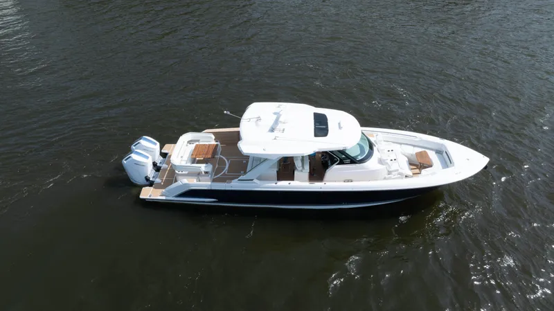 Slide: The Image of 2024 Tiara Yachts 43 LS luxury boat cruising on open water. - 19