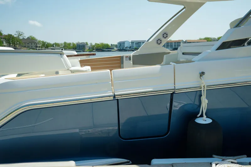 Slide: The Image of 2024 Tiara Yachts 43 LS luxury boat docked, showcasing sleek design and modern features. - 43