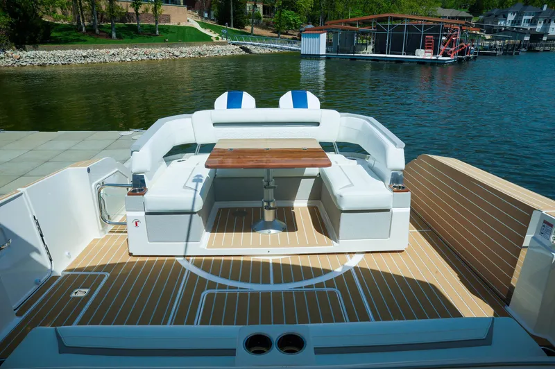 Slide: The Image of 2024 Tiara Yachts 43 LS boat with elegant seating and wooden table on deck. - 46