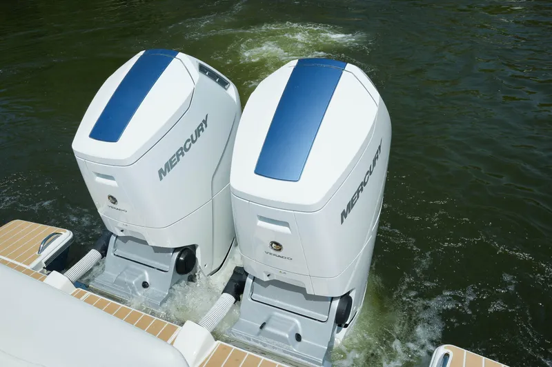 Slide: The Image of Twin Mercury outboard engines on a 2024 Tiara Yachts 43 LS, cruising in water. - 49