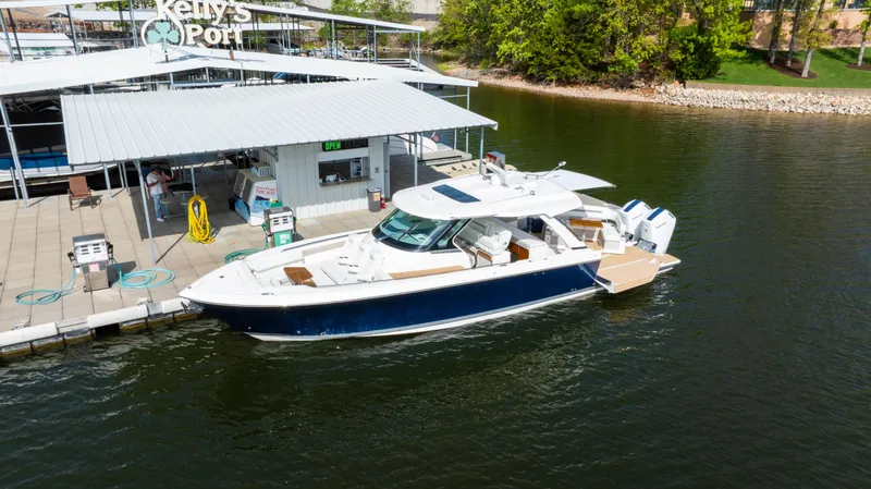 Slide: The Image of 2024 Tiara Yachts 43 LS docked at a marina, showcasing sleek design and luxury features. - 7