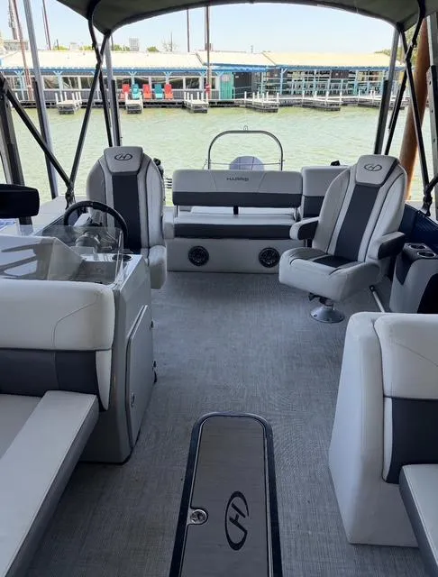 Slide: The Image of 2022 Harris Cruiser 230 interior with plush seating and modern design on a sunny day. - 11